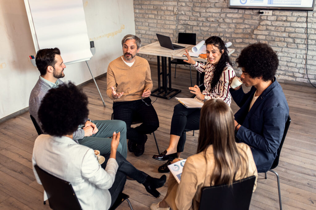 People siting in a circle being mentored